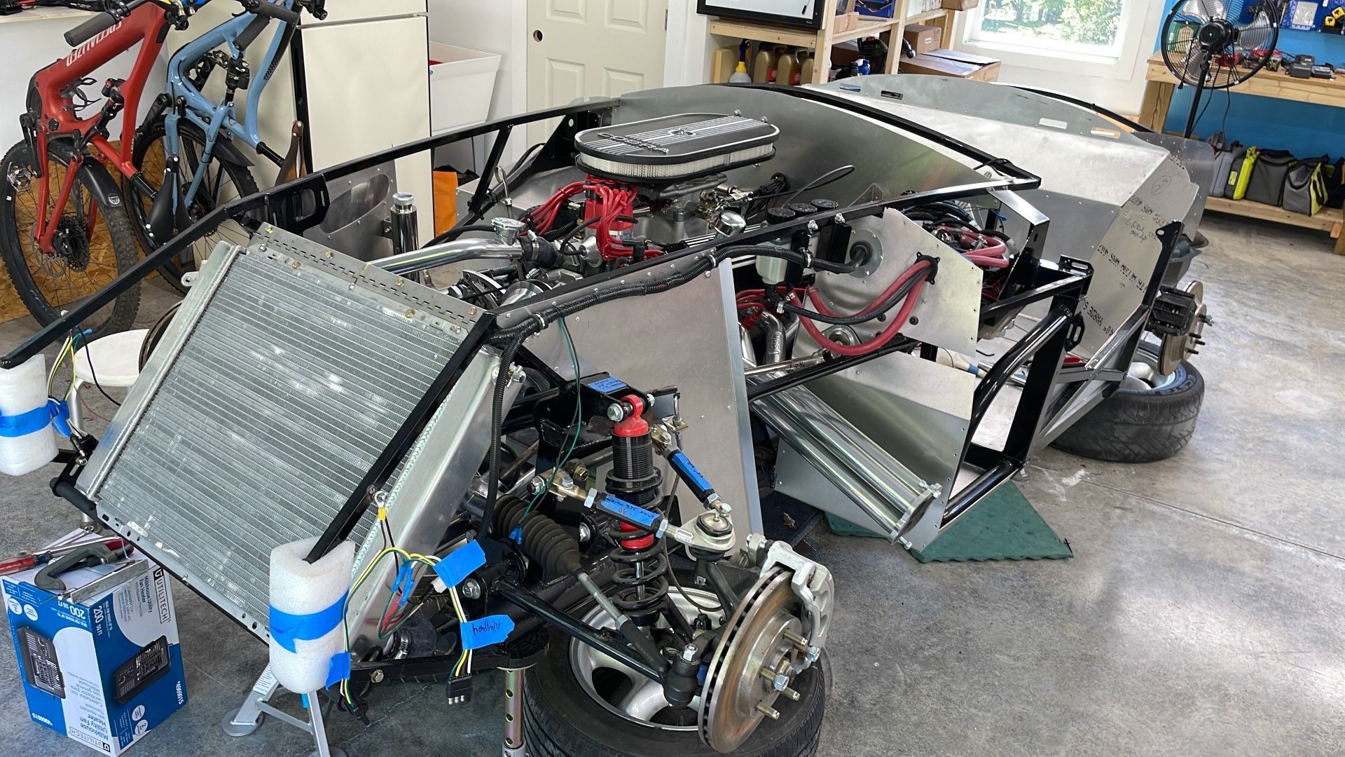 A car that is being worked on in the garage.